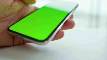 Male hands using a smartphone for scrolling the Internet close-up video