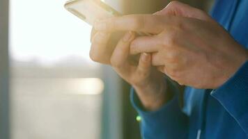 vrouw handen gebruik makend van smartphone tegen de instelling zon video