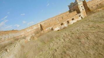 Aerial view of Staroselsky castle near Lviv, Ukraine. The train passes the castle. Shooting with FPV drone video