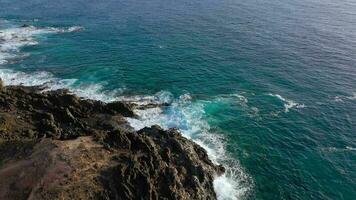 Top view of a deserted coast. Rocky shore of the island of Tenerife. Aerial drone footage of sea waves reaching shore video
