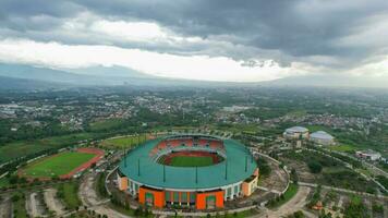 Aerial View of The largest stadium of Pakansari Bogor from drone and noise cloud. Bogor, Indonesia, March 3, 2022 photo