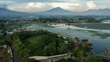 Aerial view of Situ Bagendit is a famous tourist spot in Garut with mountain view. Garut, Indonesia, May 19, 2022 photo
