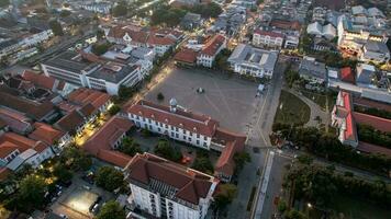 Aerial View. Fatahilah museum at Old City at Jakarta, Indonesia. With Jakarta cityscape and noise cloud when sunset. Jakarta, Indonesia, August 30, 2022 photo