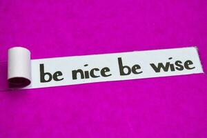 Be Nice Be Wise text, Inspiration, Motivation and business concept on purple torn paper photo