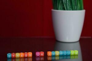 Stress or exercise text at colorful wooden block on red background. Desk office and education concept photo