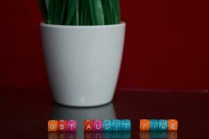 GST audit file text at colorful wooden block on red background. Desk office and education concept photo