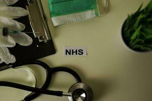 NHS with inspiration and healthcare medical concept on desk background photo