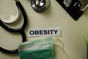 Obesity with inspiration and healthcare medical concept on desk background photo