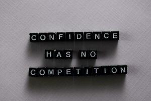 Confidence has no competition on wooden blocks. Motivation and inspiration concept photo