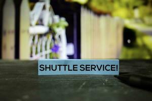 Shuttle Service on the sticky notes with bokeh background photo