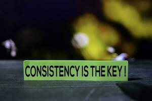 Consistency is the Key on the sticky notes with bokeh background photo