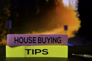House Buying Tips on the sticky notes with bokeh background photo