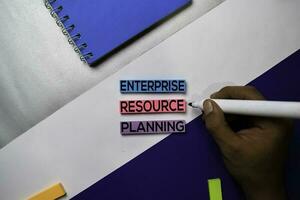 Enterprise Resource Planning text on sticky notes with color office desk concept photo