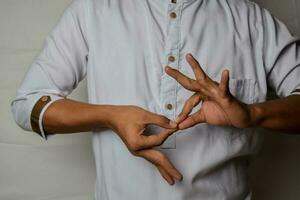 Close up Asian man shows hand gestures it means interpreter appreciation isolated on white background. American sign language photo