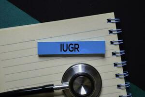 IUGR text on sticky notes. Office desk background. Medical or Healthcare concept photo