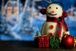 Close up decoration snowman and christmas tree isolated on bokeh background photo