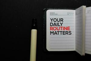 Your Daily Routine Matters. write on a book isolated on office desk photo