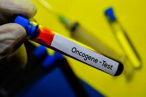 Oncogene - Test text with blood sample. Top view isolated on office desk background. Healthcare Medical concept photo