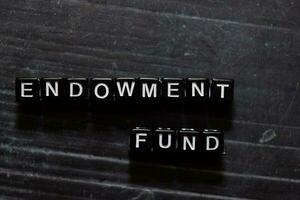 Endowment Fund on wooden cubes. On table background photo