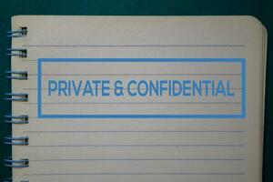 Private and Confidential write on a book isolated on green background. photo