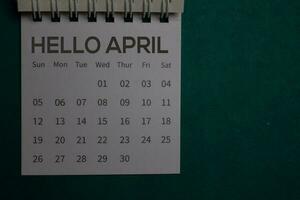 Top view Hello April text on a Calendar isolated on office desk photo