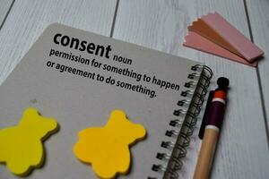 Definition of Consent word with a meaning on a book. dictionary concept photo