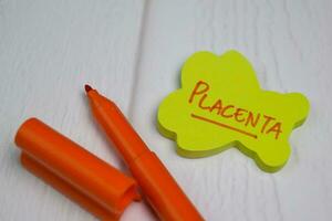 Placenta write on sticky notes isolated on office desk photo