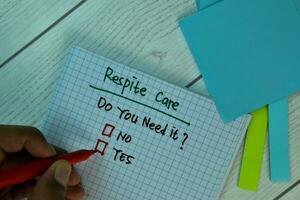 Respite Care write on a book isolated and supported by additional services isolated on Wooden Table. photo