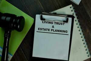 Living trust and Estate Planning text on Document form and Gavel isolated on office desk. photo