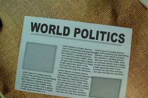 World Politics text in headline isolated on Brown burlap laying on table. Newspaper concept photo