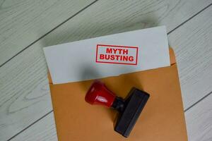 Myth Busting text on document above brown envelope. photo