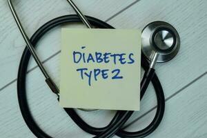 Diabetes Type 2 write on sticky notes isolated on Wooden Table. Medical concept photo