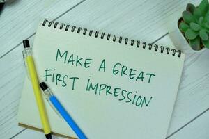 Concept of Make A Great First Impression write on a book isolated on Wooden Table. photo