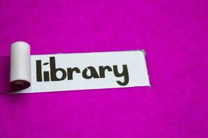Library text, Inspiration, Motivation and business concept on purple torn paper photo