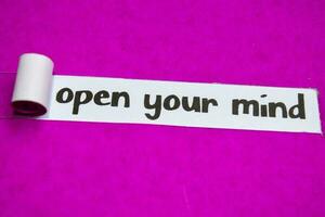 Open Your Mind text, Inspiration, Motivation and business concept on purple torn paper photo