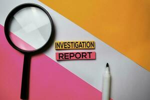 Investigation Report text on sticky notes with color office desk concept photo