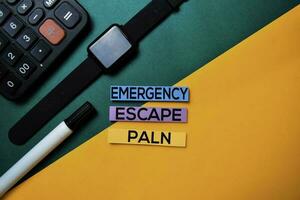 Emergency Escape Plan text on top view color table background. photo