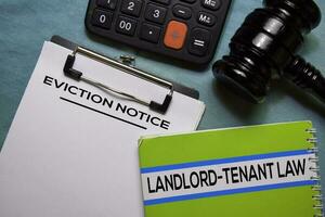 Eviction Notice text on Document form and book Landlord-Tenant Law isolated on office desk. photo