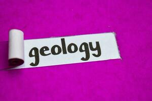 Geology text, Inspiration, Motivation and business concept on purple torn paper photo