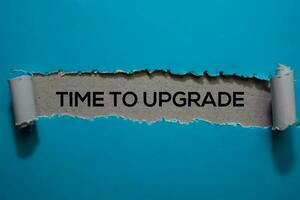 Time To Upgrade Text written in torn paper photo