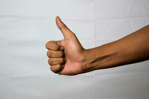 Close up Asian man shows hand gestures it means OK isolated on white background photo