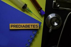 Prediabetes text on Sticky Notes. Top view isolated on yellow background. Healthcare Medical concept photo