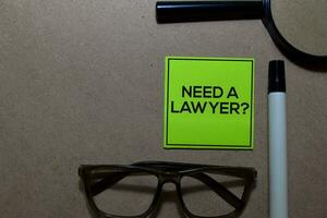 Need a Lawyer write on sticky notes isolated on Office Desk photo