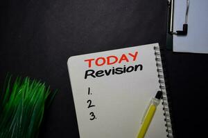 Today Revision write on a book isolated on black table. photo