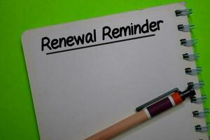 Renewal Reminder write on a book isolated on Office Desk photo