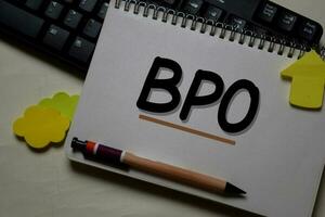 BPO - Business Process Outsourcing write on a book isolated on office desk. photo