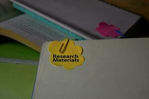 Research Materials write on a sticky note isolated on Office Desk. Business Document concept photo