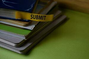 Submit write on a sticky note isolated on Office Desk. Business Document concept photo