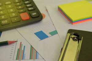 Calculator budget cost and analysis financial. Selective focus on clipboard. Business and finance concept of office desk photo