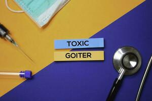 Toxic Goiter text on Sticky Notes. Top view isolated on color background. Healthcare Medical concept photo